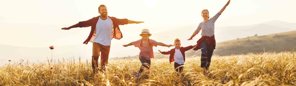 Happy family: mother, father, children son and  daughter on nature  on sunset