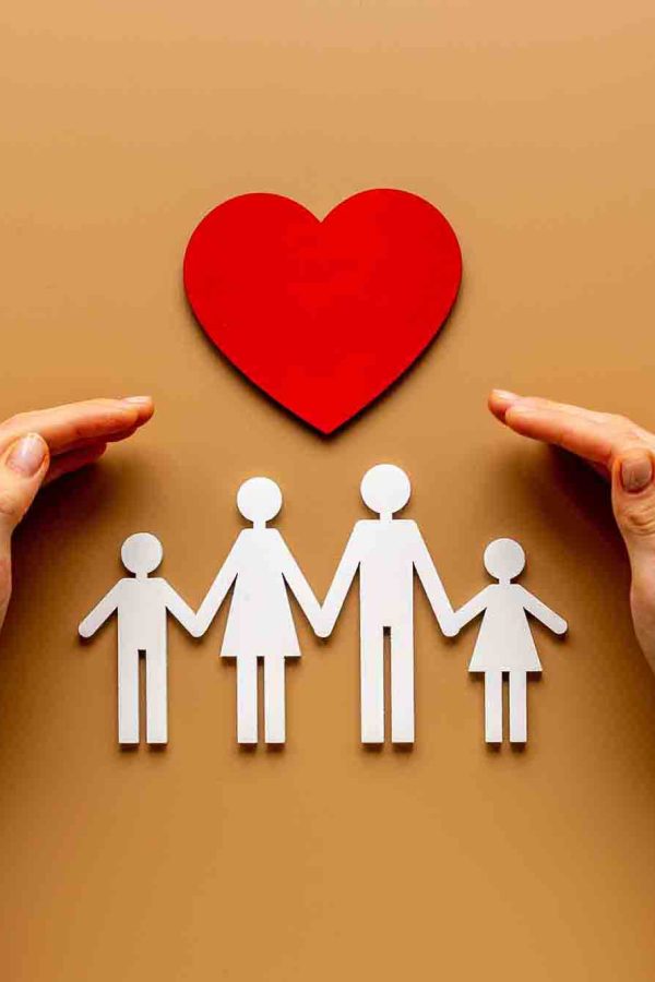 Hands holding family figure. Life and health insurance concept.